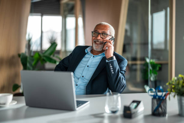 istock Senior Diverse Executive Engaging in Conversation via Smartphone 2170259143