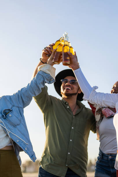 istock Diverse Group Toasting with Beer on Beach at Sunset 2170260782