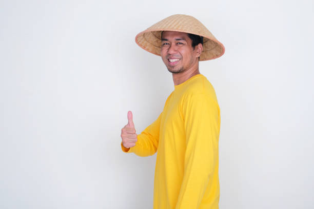 A farmer turning around and give thumbs up with happy expression