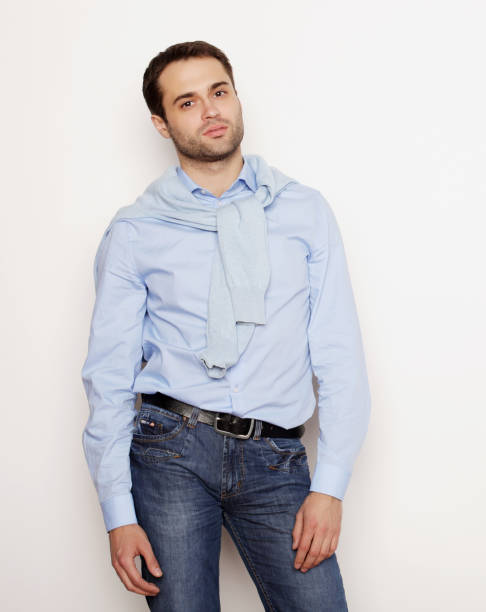 istock happy young man in blue shirt. 2170262173