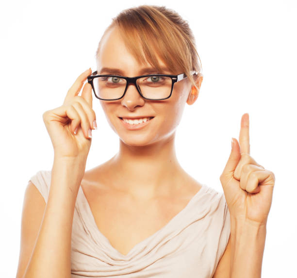 istock woman wearing glasses pointing up 2170262287