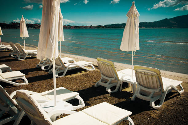 travel concept - sunchairs with  umbrellas on beautiful  beach, Zakynthos  island, Greece