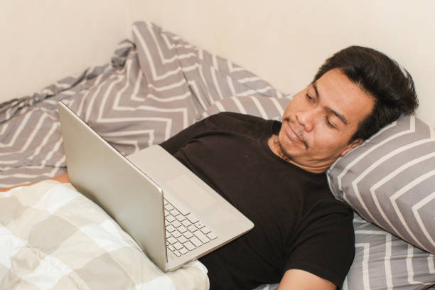 istock A Southeast Asian man watching movie in bed 2170263854