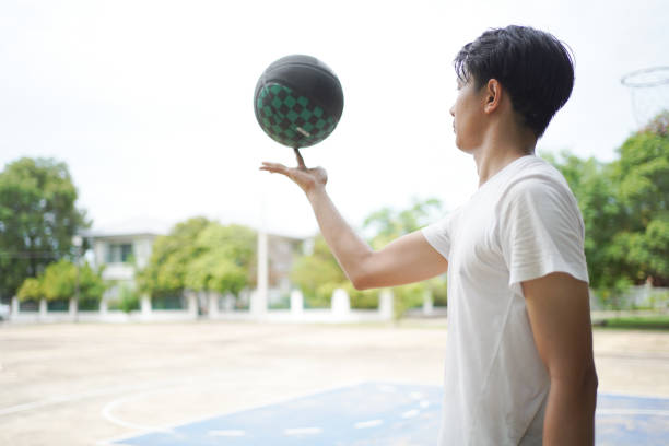 Sporty woman about to take a shot with a basketball, low angle view