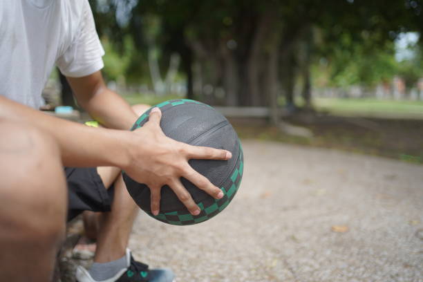 istock Asian man is playing basketball at street course. 2170265979