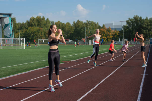 istock Group of young athletes training at the stadium 2170267840