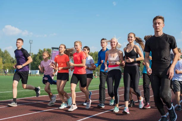 istock Group of young athletes training at the stadium 2170267871
