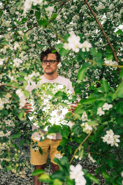 istock Creative male portrait with mirror in blooming apples spring garden 2170267920