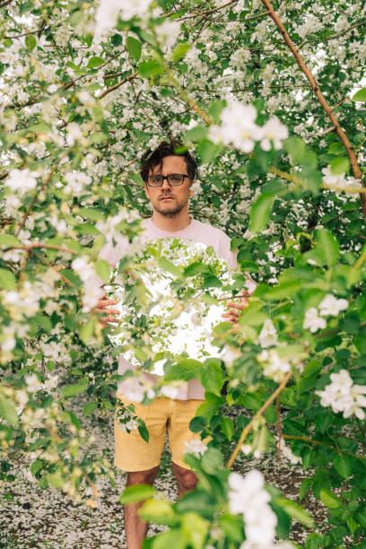 istock Creative male portrait with mirror in blooming apples spring garden 2170267925