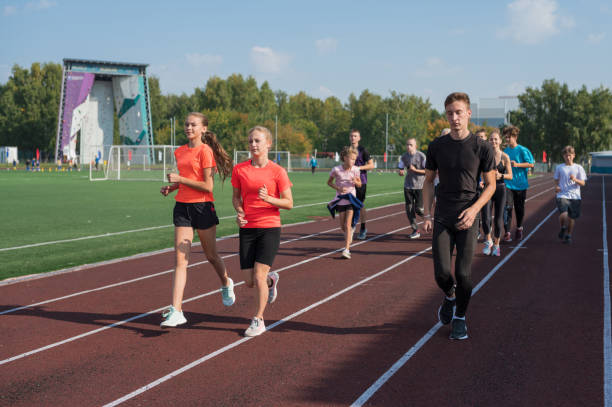 istock Group of young athletes training at the stadium 2170267930