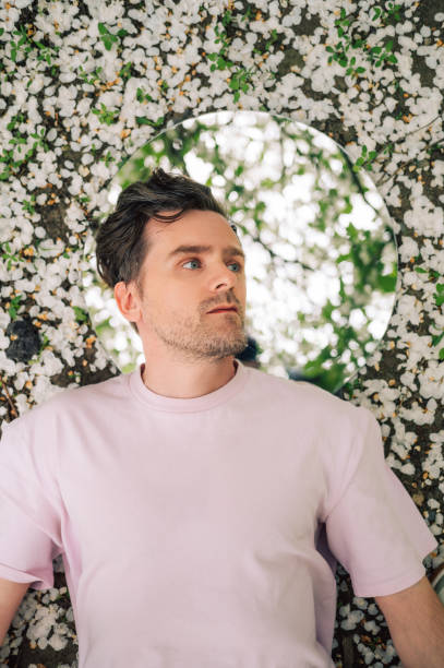 istock Creative male portrait with mirror in blooming apples spring garden 2170267931