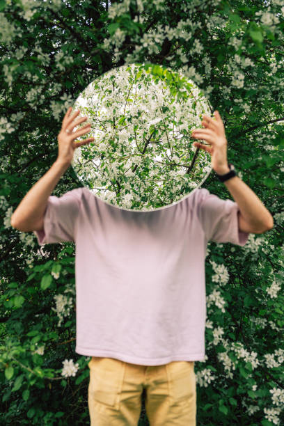istock Creative male portrait with mirror in blooming apples spring garden 2170267949