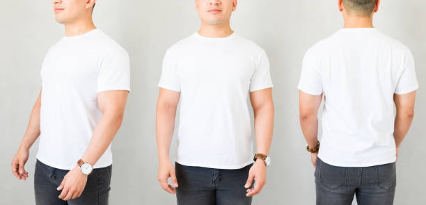 istock Man presenting a white t-shirt mockup, with front, back and side view, on a plain background 2170270450