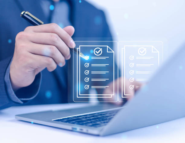 istock Businessman using tablet and laptop to fill out online survey. Digital form checklist. White background 2170272479