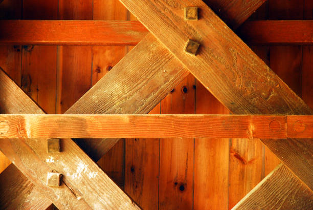 The wood beams make up the inner workings of a New England covered bridge shows the engineering of a bygone era