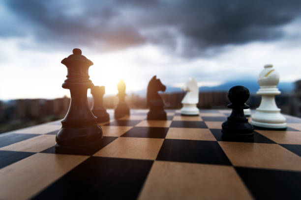 istock Black and white chess pieces battle on the board 2170275409