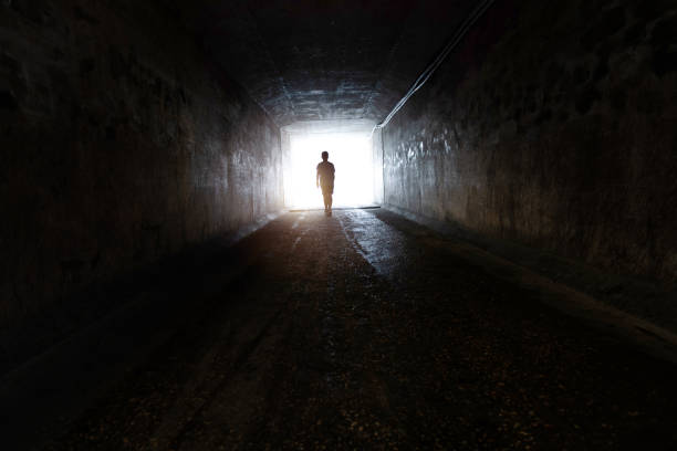 istock A boy standing at the end of the tunnel 2170275572