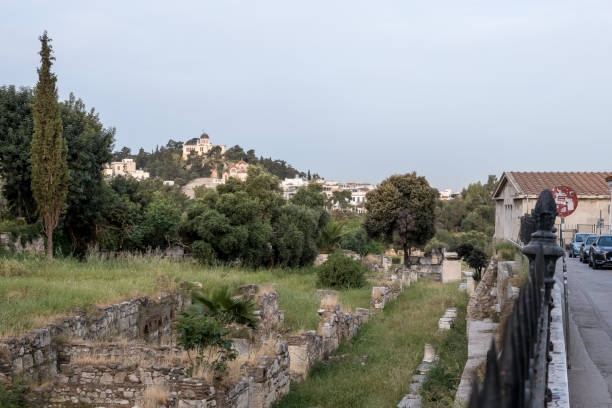 View of the Roman Agora in Athens' Old Town Sunrise view of the Roman Agora in Athens' Old Town, a significant archaeological site made of ancient ruins and open spaces, with the Acropolis towering in the background. Located north of the Acropolis and east of the Ancient Agora, the Roman Agora served as a bustling center of public life in ancient Athens, featuring a mix of marketplaces, public buildings, and temples. nike air photos stock pictures, royalty-free photos & images