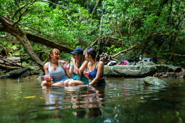 istock Three women sitting in a river to stay cool 2170279205