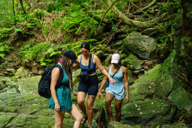 istock Three women walking in a river for a weekend adventure 2170279220
