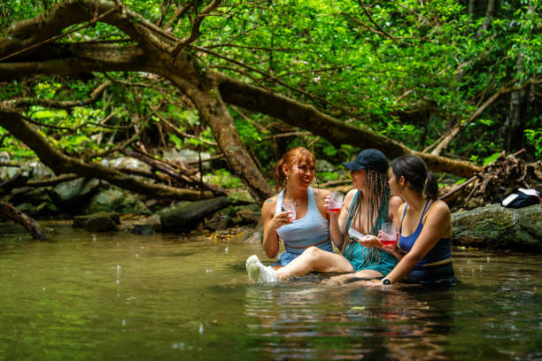 istock Three women sitting in a river to stay cool 2170279235