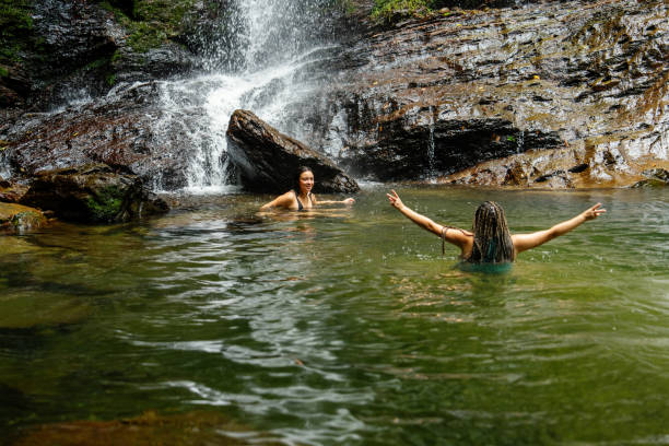 istock Two women swimming under a waterfall 2170279241