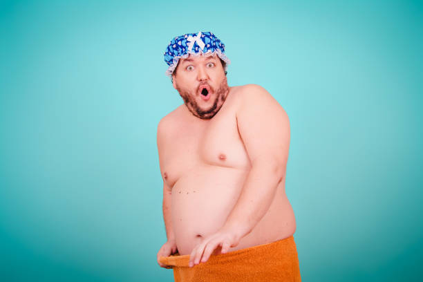 istock Funny fat man after a shower. Blue background. 2170285192
