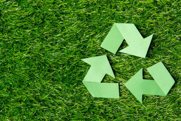 istock A green recycling symbol on a lush grass background with copy space. 2170286396