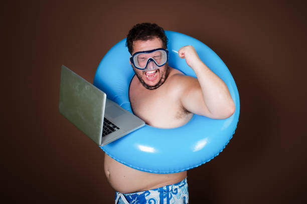istock Funny fat man with an inflatable ring is going on vacation. 2170286893