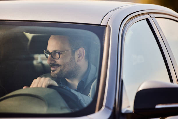 istock Smiling businessman going on a trip by car. 2170286934
