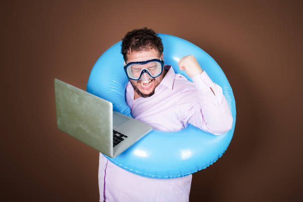 istock Funny fat man with an inflatable ring is going on vacation. 2170286994