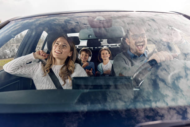 istock Happy family having fun while going on a vacation by car. 2170287188