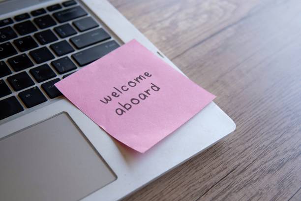 istock A close-up of a laptop keyboard with a pink sticky note attached with text Welcome aboard. 2170287410