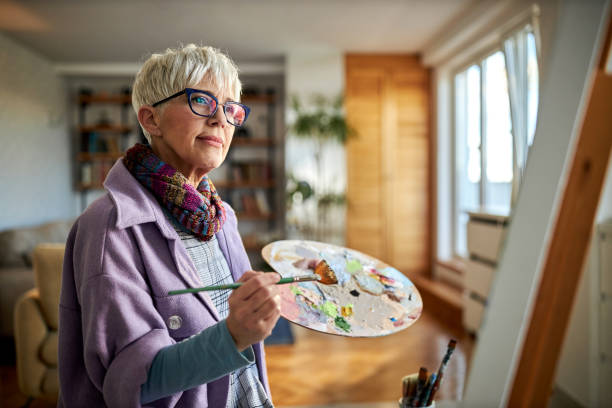 istock Mature female painter enjoying while painting in art studio. 2170287714