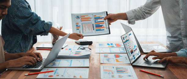 istock Analyst team utilizing BI Fintech to analyze financial report. Scrutinize 2170288872