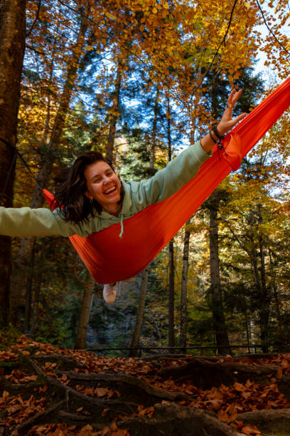 istock Relaxing in a Hammock in Autumn Forest 2170290659