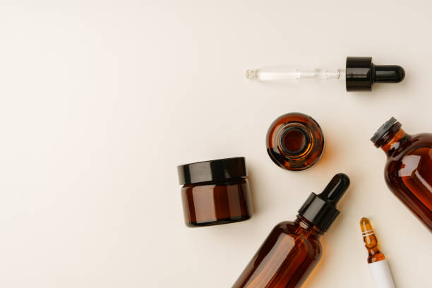 istock Various Amber Glass Containers for Essential Oils and Skin Care Products Displayed on Light Background 2170291367