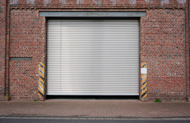 istock Old rolling garage door and brick wall 2170291418
