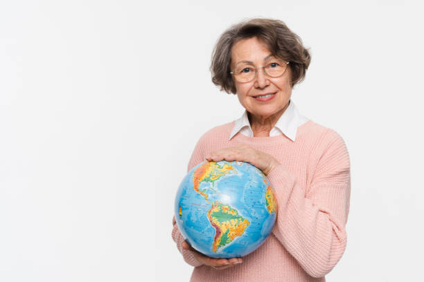 istock Smiling elderly woman holding hugging embracing planet Earth globe isolated . Geography traveling . 2170291641