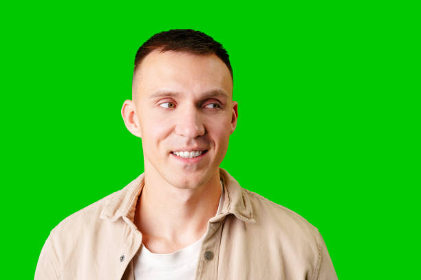 istock Smiling Man With Short Hair Posing Against Bright Green Backdrop 2170291800