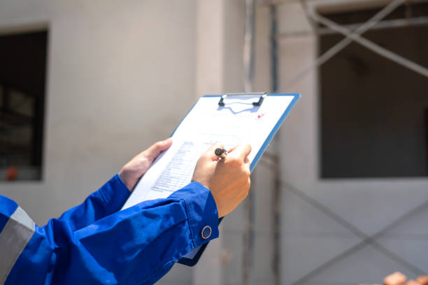 istock An architect is checking on house building quality checklist. 2170291823