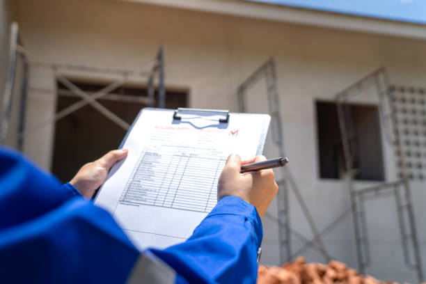istock An architect is checking on house building quality checklist. 2170291827