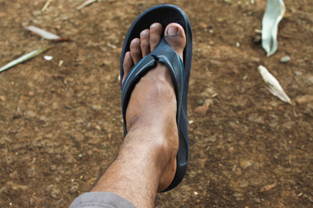 brown skin asian man wearing sandals