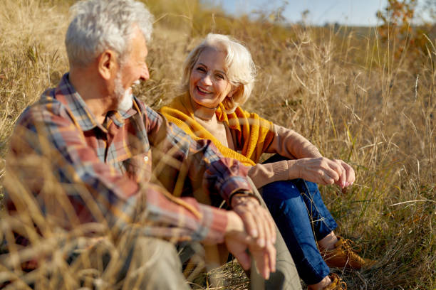 istock Happy mature couple talking during autumn day in tall grass. 2170294095