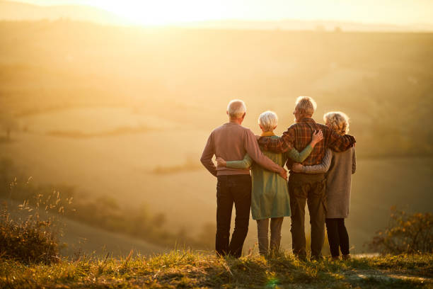 istock Back view of embraced seniors looking at sunset view from a hill. 2170294162