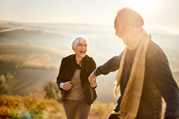 istock Playful senior couple having fun in autumn day on a hill. 2170294319