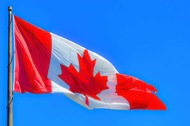 istock Canadian Flag Blue Clear Sky 2170296724