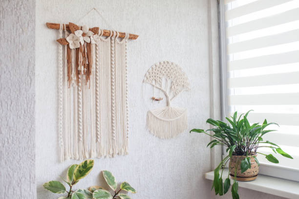 istock Wall hanging macrame hand made on white wall. ECO friendly modern knitting DIY natural decoration concept in the interior. Handmade 100% cotton, female hobby. 2170297989