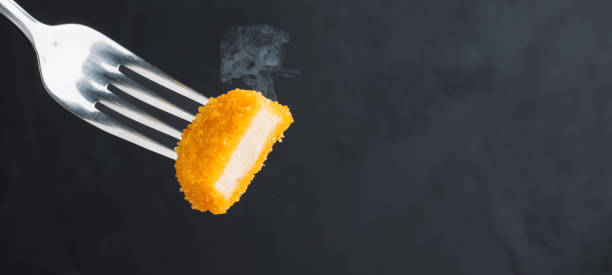 istock Delicious chicken nuggets on black background. Cooked or raw chicken nuggets 2170298785
