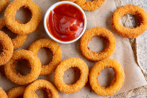 istock Fried onion rings with mozzarella or plain. Delicious onion rings on table 2170298786